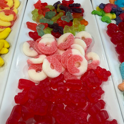 Assorted colorful gummy candies on a white tray