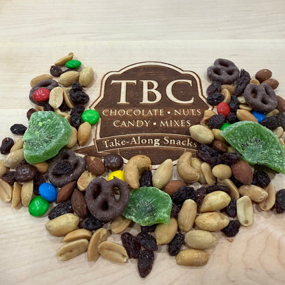 Assorted snack mix with TBC branding on a wooden surface