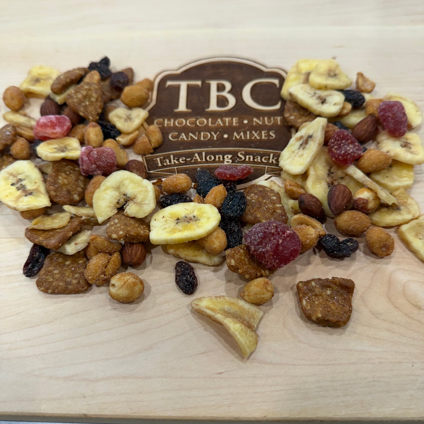 Sweet healthy snacks including banana chips, dried strawberries, nuts, and raisin.